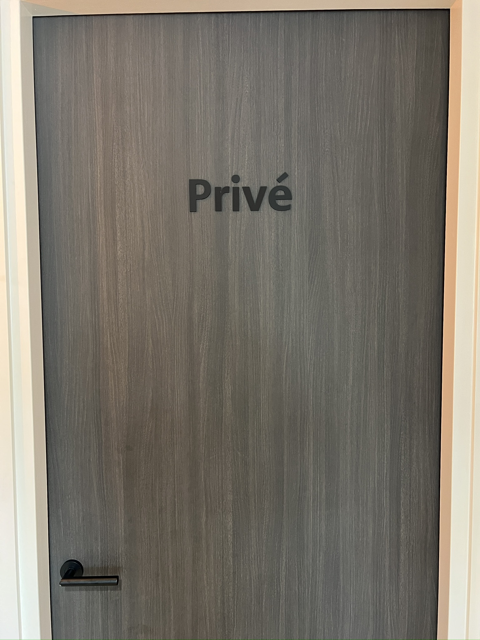 Donkere deur met het woord Privé in losse freesletters