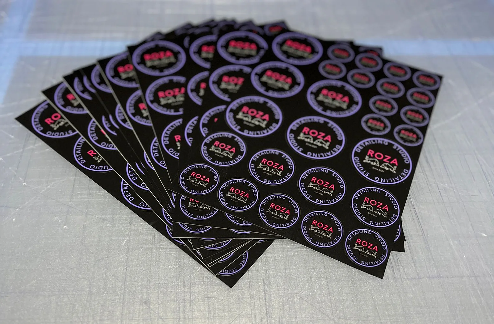 Meerdere geproduceerde stickervellen met ronde logostickers in verschillende formaten